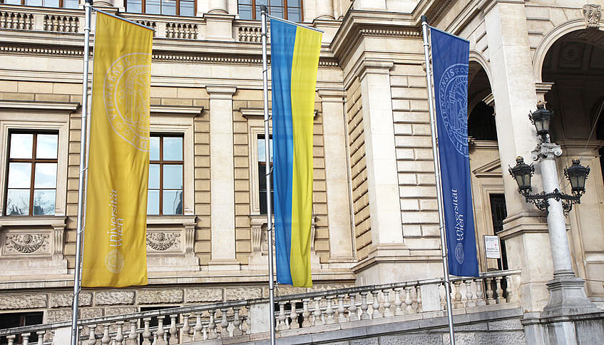 Front view of the main building of the Univertsity of Vienna with a Ukrainian flag